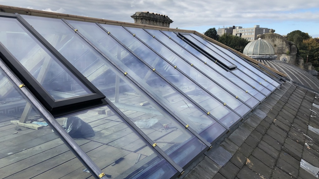 PHD Building Advisory surveying a complex glazed roof